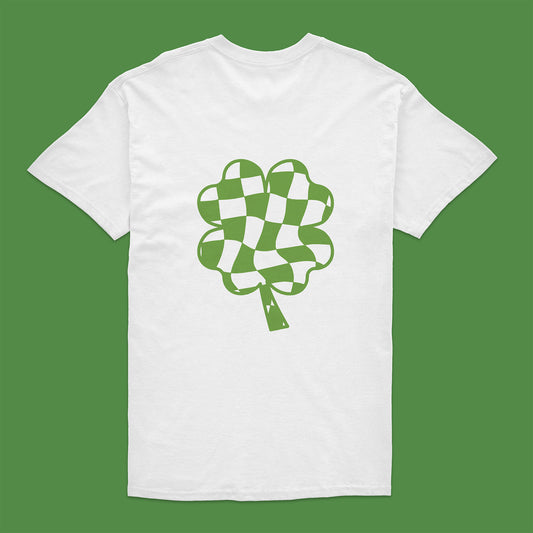 White t-shirt with green checkered clover design on a green background