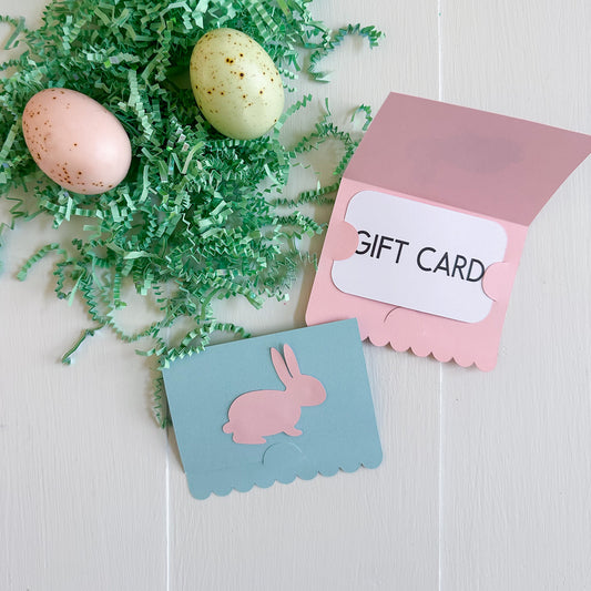 Easter-themed gift card with pink envelope and blue card with rabbit design on a white background.
