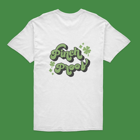 White t-shirt with 'Pinch Proof' text and clover leaves on a green background