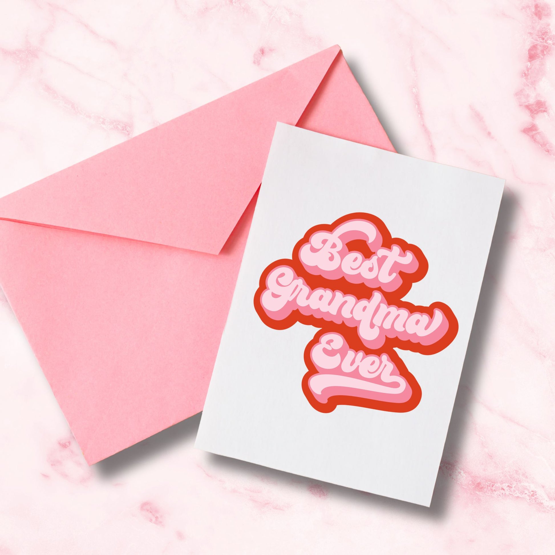 Greeting card with 'Best Grandma Ever' text on a pink envelope against a pink marble background