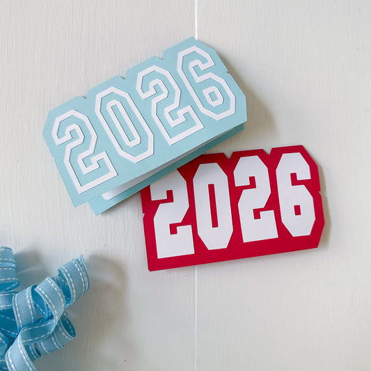 Two '2026' gift card holder one blue and one red, on a white background with a blue ribbon.