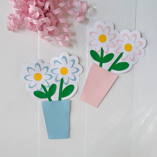 Paper flower gift card holders with pink ribbons on a white background