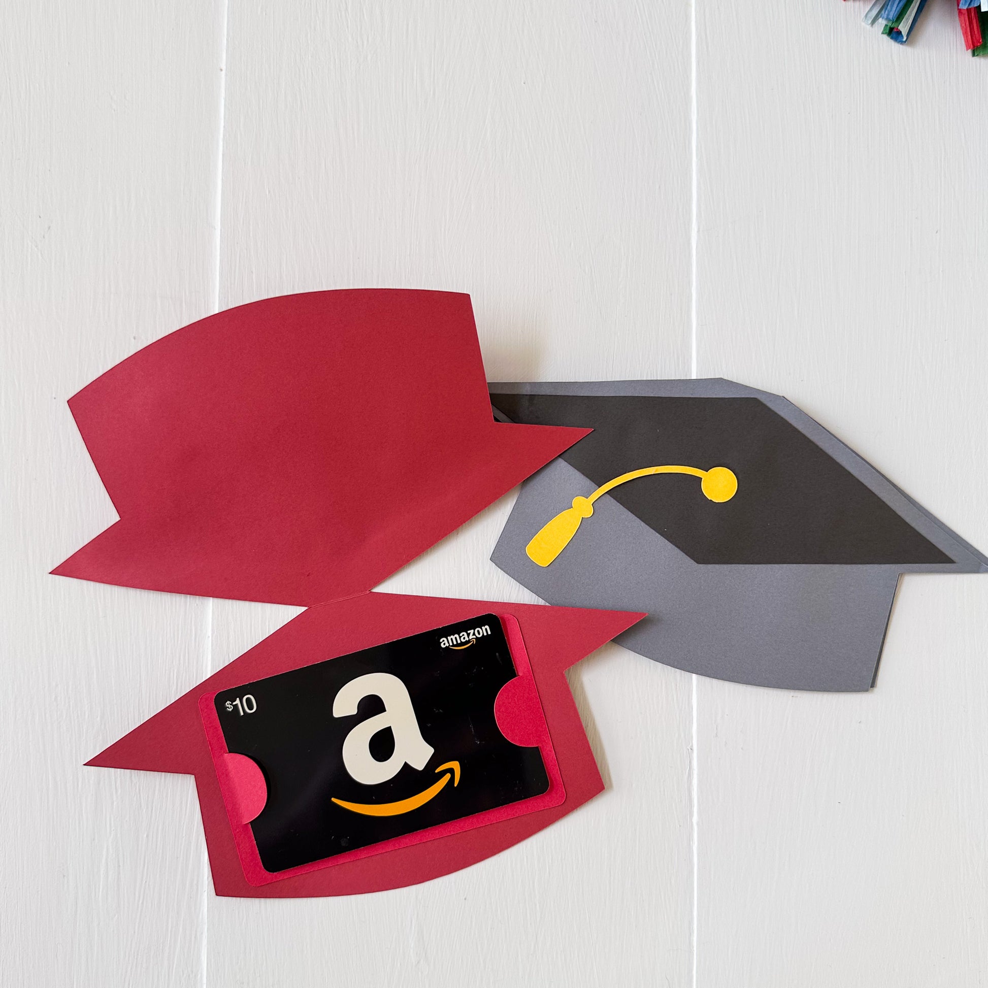 Graduation-themed gift card holder with Amazon gift card on a white surface