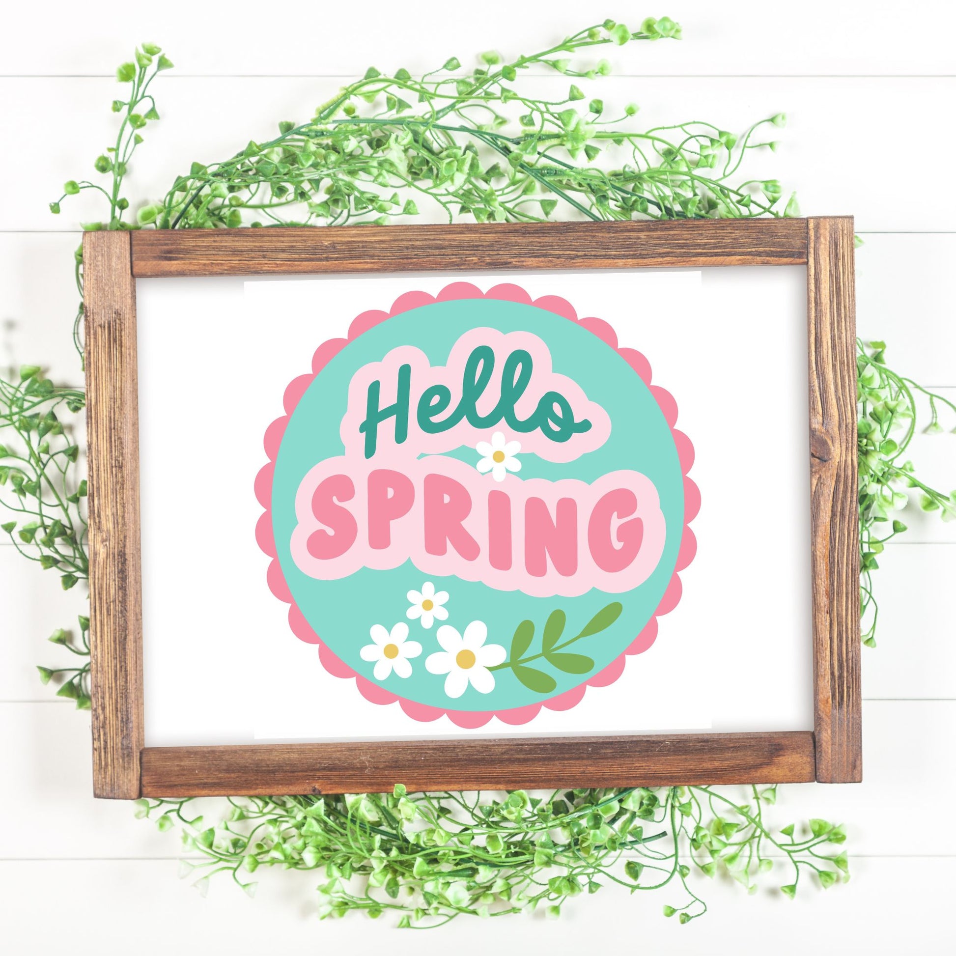 Framed 'Hello Spring' sign with decorative elements on a white background